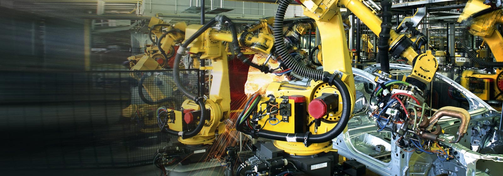 Robots spot welding body panels 